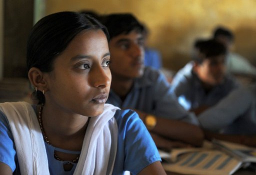  Padma Kanwar Bhatti sitting among a classroom of boys during a lesson. ©AFP