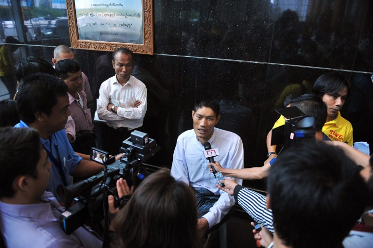 Win Zaw Oo (C) speaks to the media at the international airport in Yangon. ©AFP