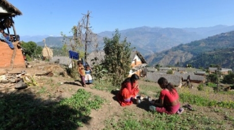 Chandrakal Nepali (C) eats as children look on in the village of Achham. ©AFP 