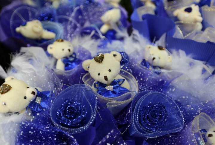 A bouquet made of blue roses and little teddy bears on sale on the Valentines Day in Beijing, China. ©Reuters