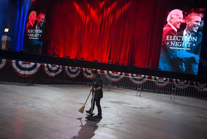 A woman cleans the floor near the stage at McCormick Place, the site for U.S. President Barack Obama's post election speech, in Chicago. ©REUTERS/Adrees Latif