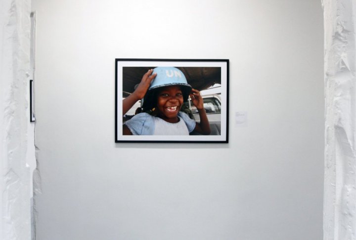 Haiti girl wearing a UN peacemaker helmet. <br>UN Photo/Logan Abassi©
