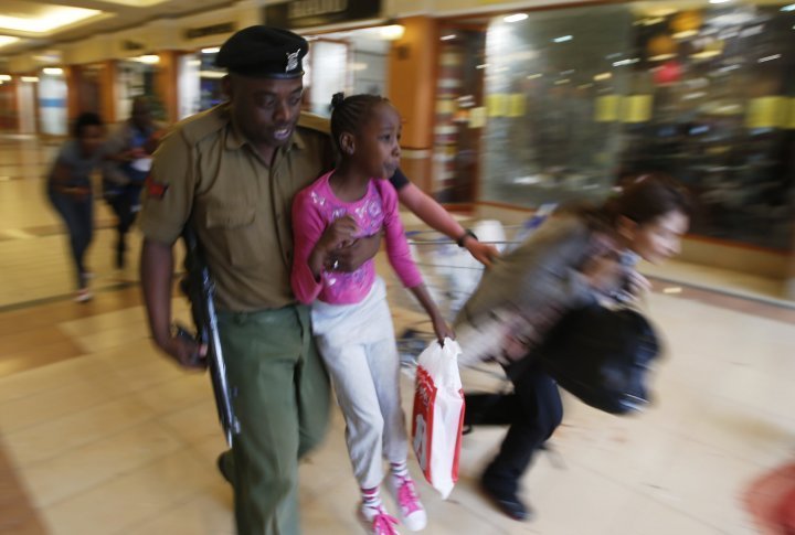 A soldier carrying a child out of the mall. ©REUTERS