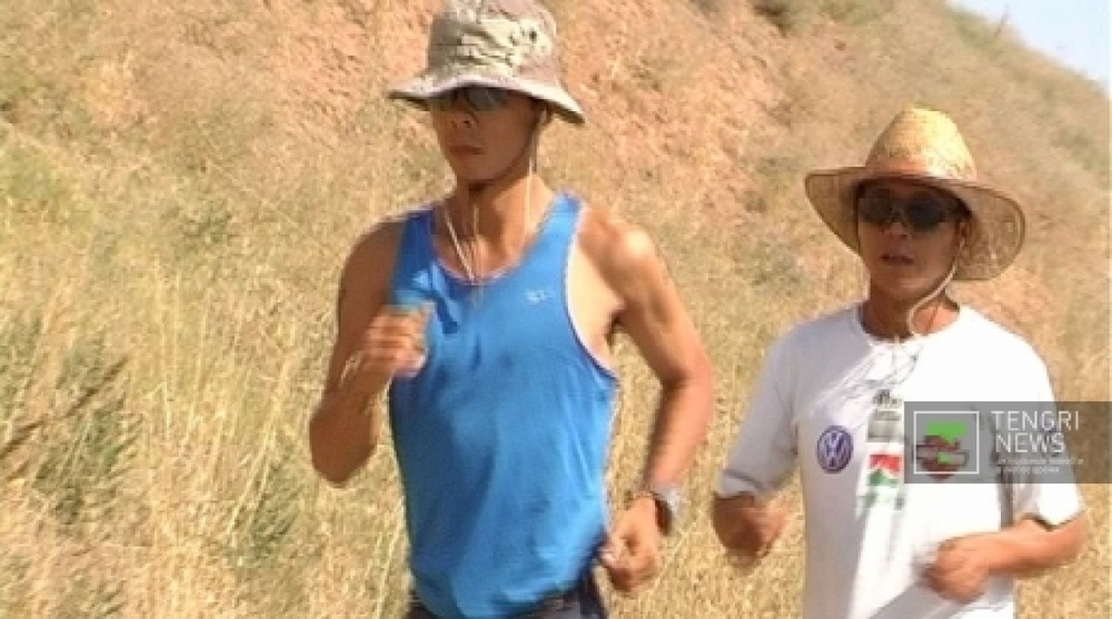 Kevin Li (L) and Chen Jan (R) from Taiwan running to Shymkent. Tengrinews.kz stock photo
