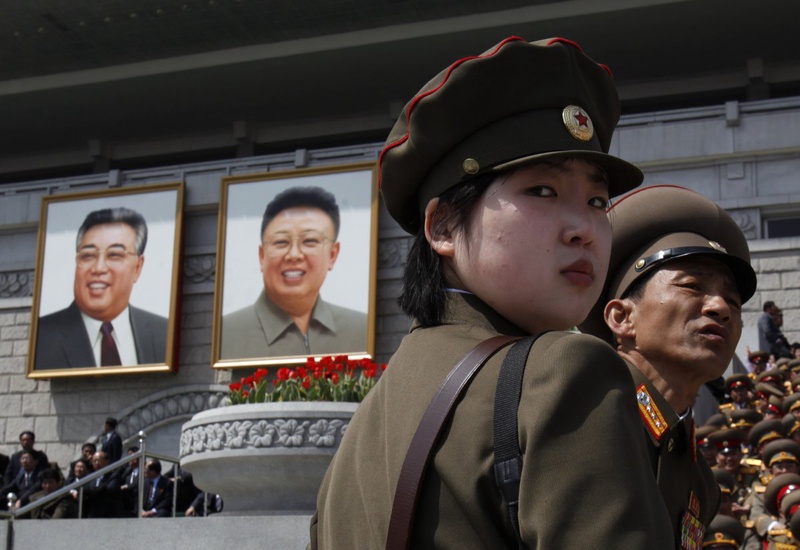 Soldiers stand in front of the podium with portraits of North Korea founder Kim Il-sung and the late leader Kim Jong-il. ©REUTERS/Bobby Yip 