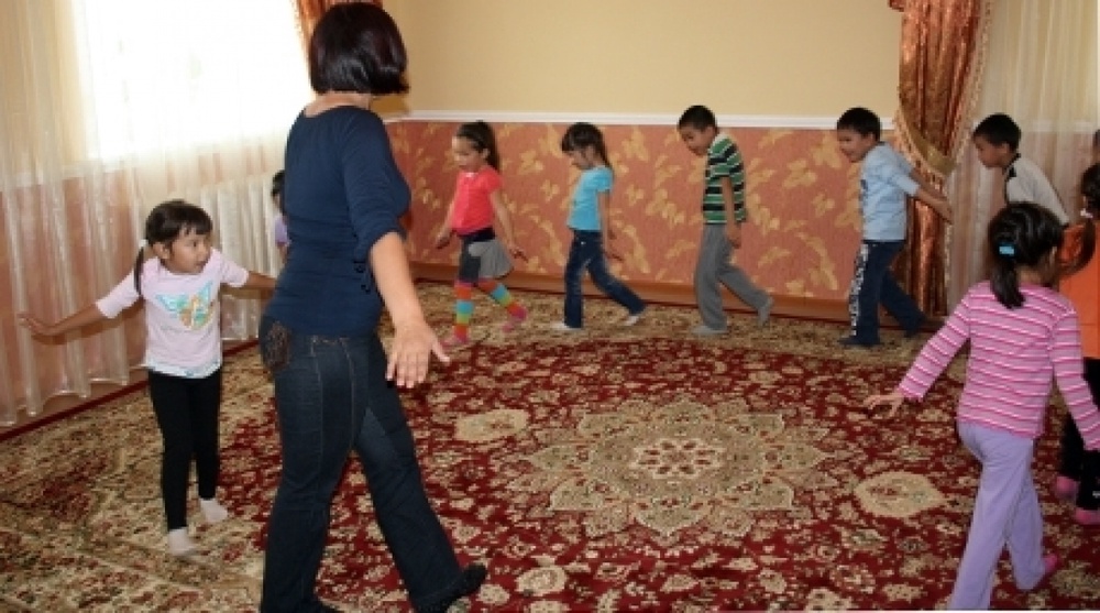 Children are playing with their teachers in kindergarten. Vesti.kz stock photo
