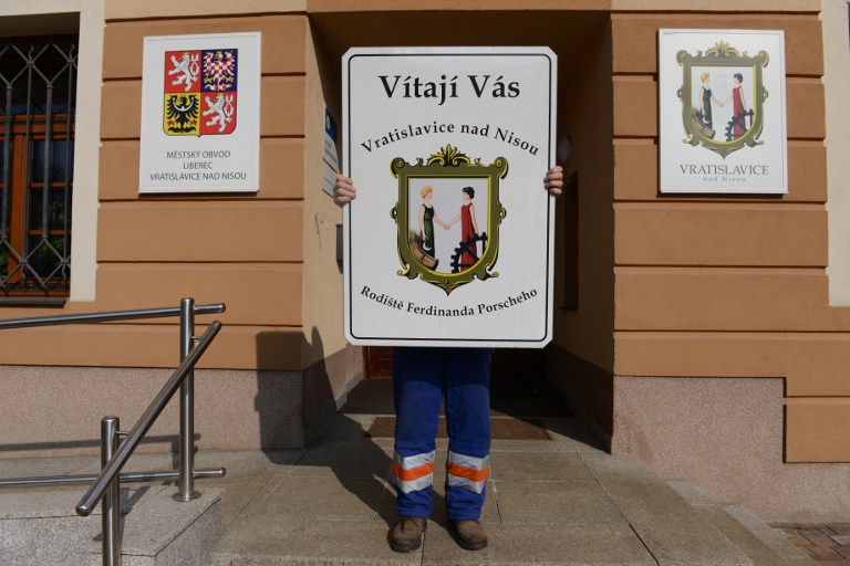 A municipal employee shows the former welcoming sign of the Vratislavice village reading ''Welcome to Vratislavice and Nisou, native place of Ferdinand Porsche