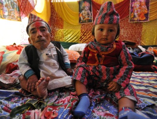 Chandra Bahadur Dangi (L), a 72-year-old Nepali sits next to a child. ©AFP