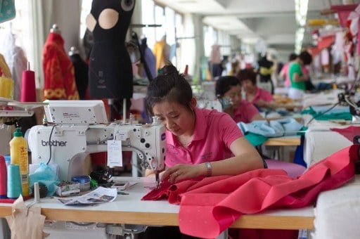 A worker at a sewing machine at Rose Studio. ©AFP