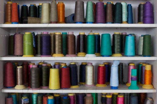 Spools of thread on shelves at Rose Studio. ©AFP