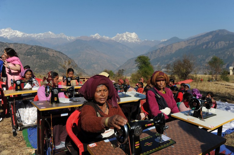 Indian widows, who lost their husbands during massive floods in the northern Indian states last June, take part in vocational training at Deoli-Bhanigram village in India's northern Uttarakhand state. ©AFP