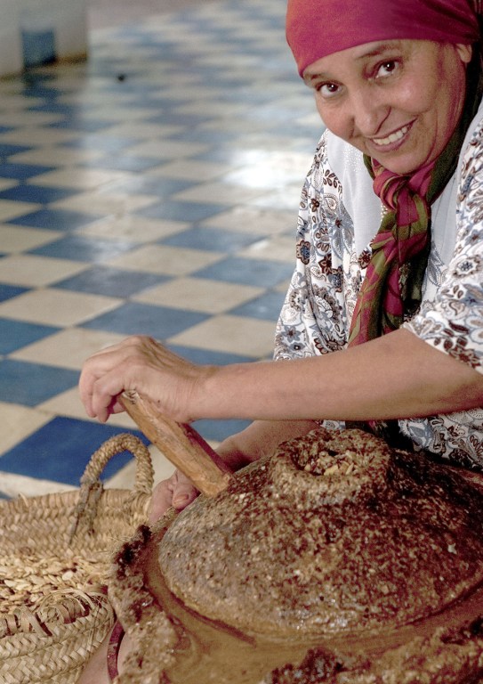 A woman grinds nuts from the Argan tree to extract the kernel. ©AFP
