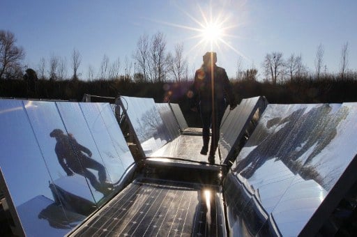 Engineers check a floating photovoltaic panel system. ©AFP