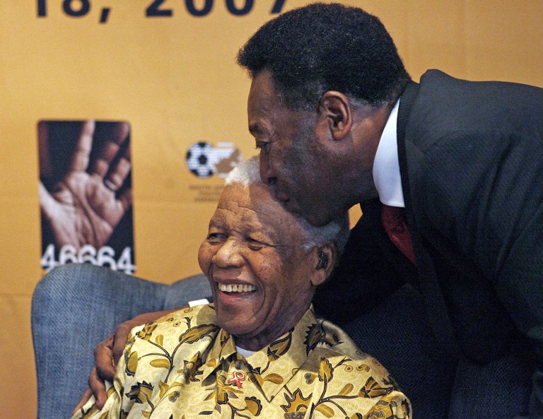 Brazilian football legend, Pele (R) kisses former South African President, Nelson Mandela, 17 July 2007 in Johannesburg, South Africa.