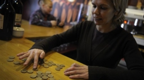 The owner of a coffe-bar counts pesetas coins in Salvaterra de Mino, northwestern Spain. ©AFP 