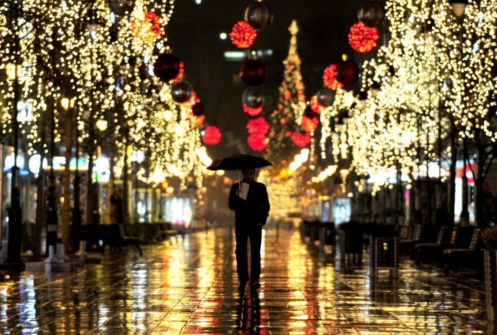 A man walks down the alley of trees illuminated with Christmas lights in Skopje, Macedonia. ©Reuters/Ognen Teofilovski