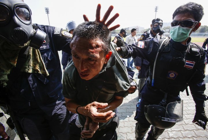 Policemen arresting a protester. ©Reuters