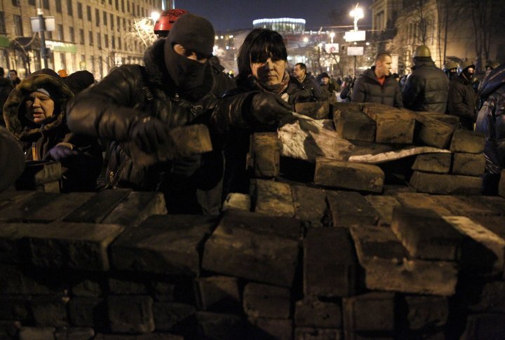 The Anti-government protestors are building a barricade using the pavement slabs in Kiev. ©Reuters