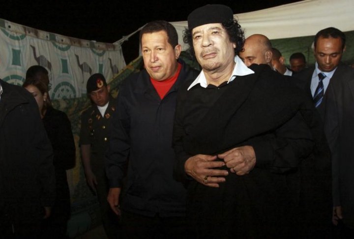 Venezuelan President Hugo Chavez (C) is greeted by Libyan leader Muammar Gaddafi (R) upon his arrival in Tripoli. ©REUTERS/Miraflores Palace/Handout