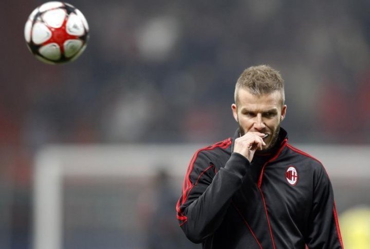 AC Milan's David Beckham looks on during a warm-up session before their Champions League soccer match against Manchester United. ©REUTERS/Alessandro Bianchi