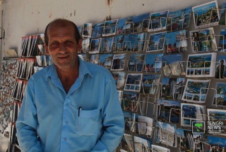 Zhussul Dursynov has been working in Antalya every summer for the last 4 years. He sells postcards and souvenirs. He says that Turkey is the best country for leisure. Photo by Vladimir Prokopenko©