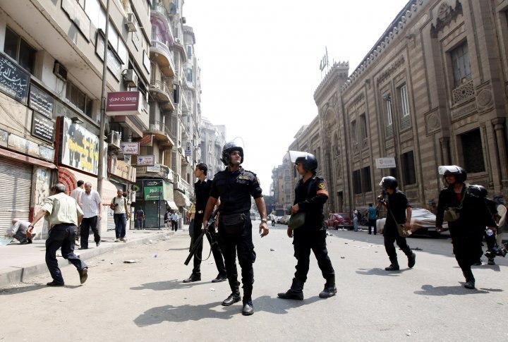 Police walk in the middle of a street during clashes in central Cairo August 13, 2013. ©REUTERS