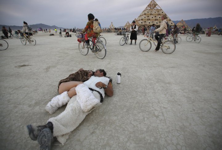 Participants cuddle at sunrise at the Temple of Whollyness. ©REUTERS