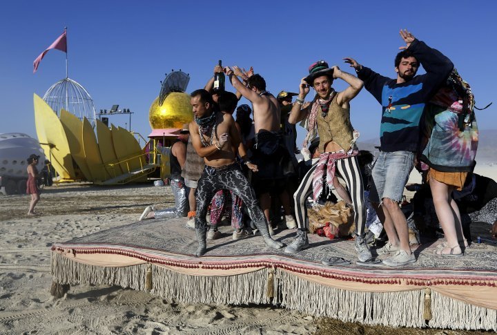 Participants dance atop a moving "hookah lounge" art car. ©REUTERS