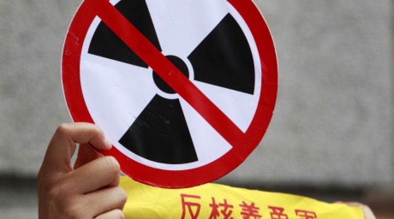 Activist holding an anti-nuclear poster. ©REUTERS/Nicky Loh