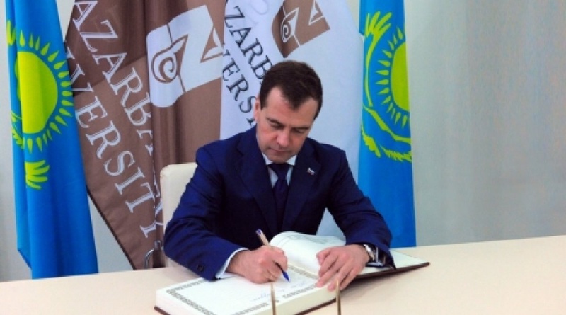 Dmitry Medvedev is singing the Book of guest of honor. Photo courtesy of pm.kz