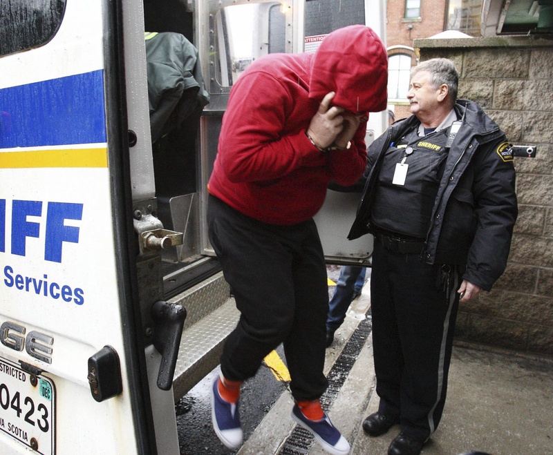 Jeffrey Paul Delisle jumps out of a Sheriff van after arriving at the provincial court in Halifax. ©REUTERS/Paul Darrow 