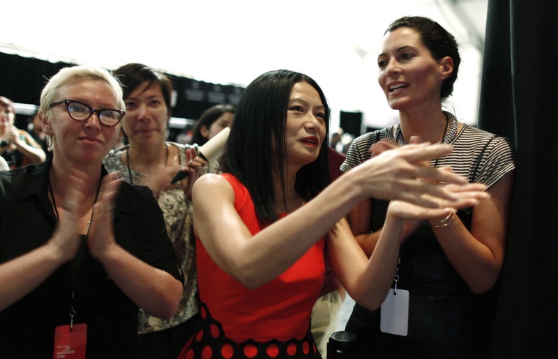 Designer Vivienne Tam (C) reacts backstage at the end of her Spring/Summer 2013 collection show at New York. ©REUTERS/Carlo Allegri 