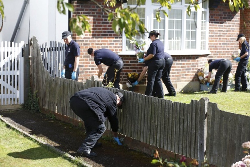 British police personnel carry out a search of the home of Saad and Iqbal al-Hilli.