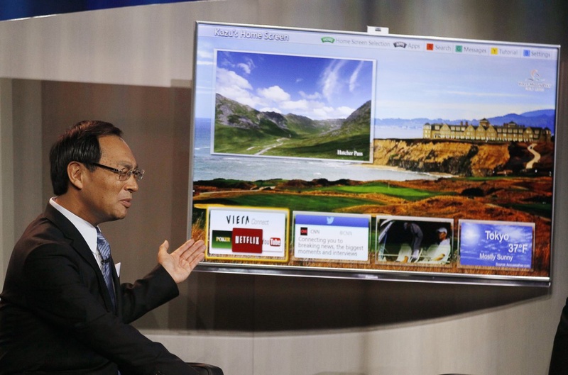 Panasonic chief Kazuhiro Tsuga shows off one of his company's Smart TVs.  ©REUTERS/Rick Wilking 