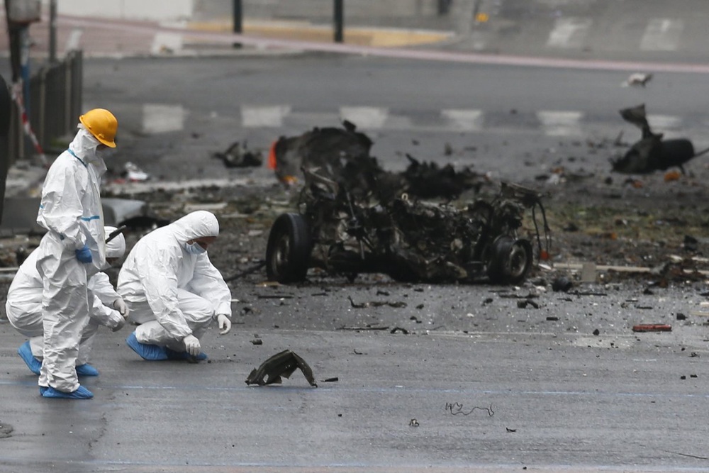 Forensic experts search for evidence amid the debris on a street where a car bomb went off in Athens. ©Reuters/Alkis Konstantinidis