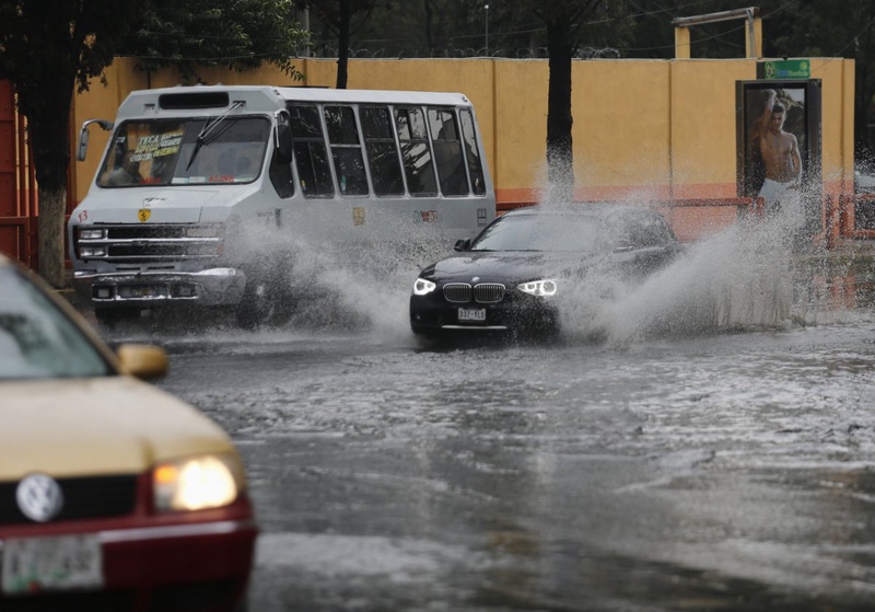 Vehicles drive through a flooded street after torrential rains hit several neighborhoods in Mexico City. ©Reuters/Bernardo Montoya