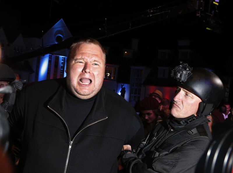 An actor in police costume mock-arrests Megaupload founder Kim Dotcom. ©Reuters/Nigel Marple