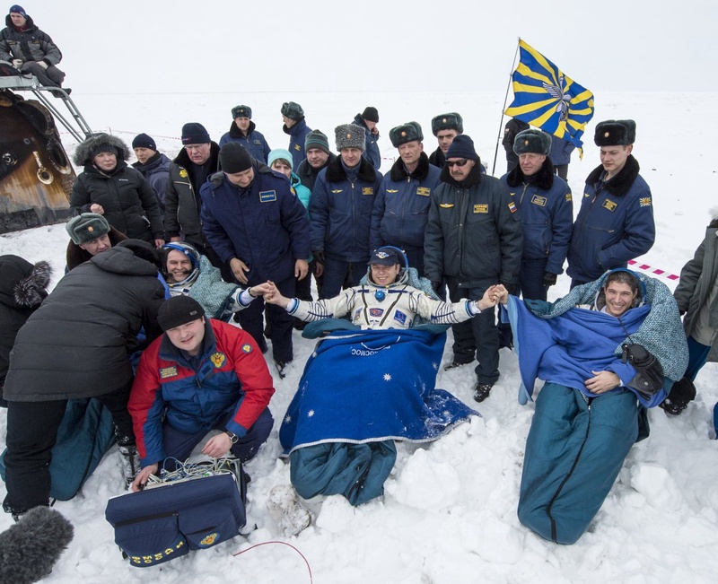 Former ISS commander Oleg Kotov (C) and flight engineers Sergei Ryazansky (L) and Michael Hopkins from NASA sit in chairs outside the Soyuz TMA-10M capsule. ©Reuters/Bill Ingalls