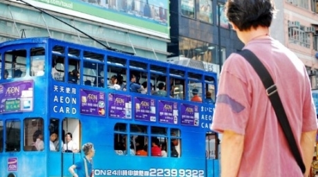 Passengers riding a tram running in Hong Kong. ©AFP